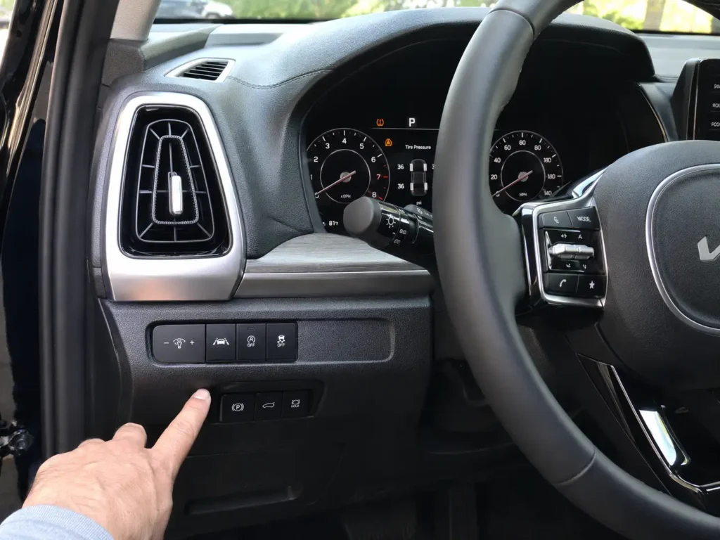 Kia Sorento TPMS reset button location near lower dashboard